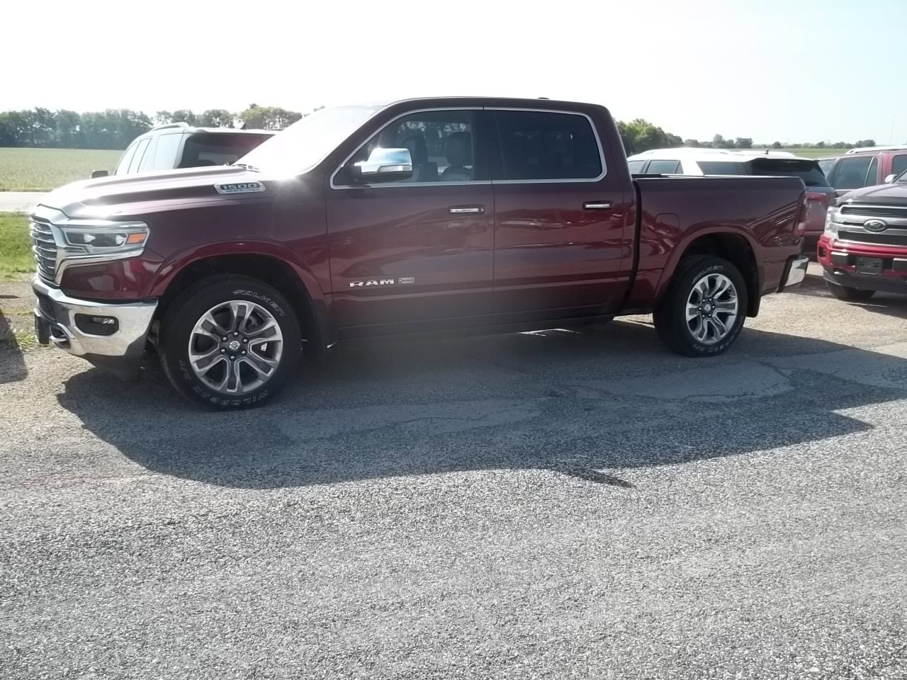 2021 RAM 1500 Longhorn in Delmonico Red Pearlcoat — front three-quarter view