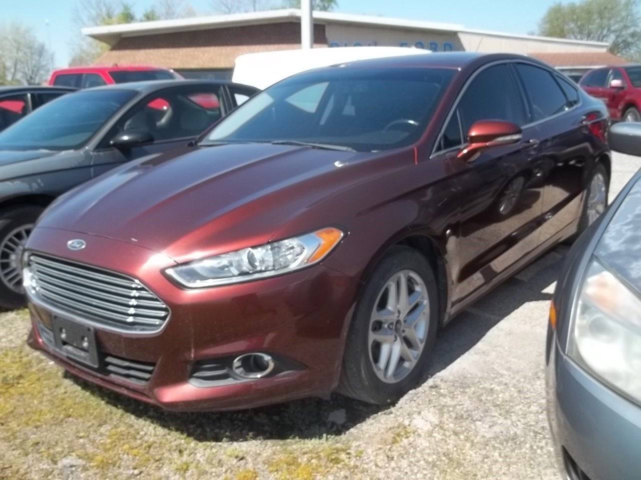 2015 Ford Fusion SE in Bronze Fire Metallic Tinted Clearcoat — front three-quarter view